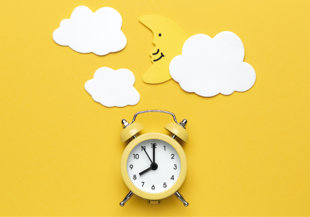 Yellow background with an alarm clock in the middle. Above the clock are white clouds and a moon