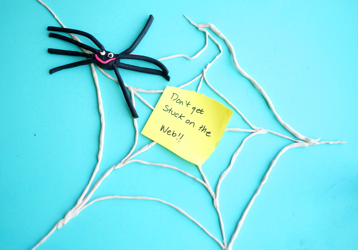 Image of a spider and its web with the words "Don't get stuck on the web" on a post-it note